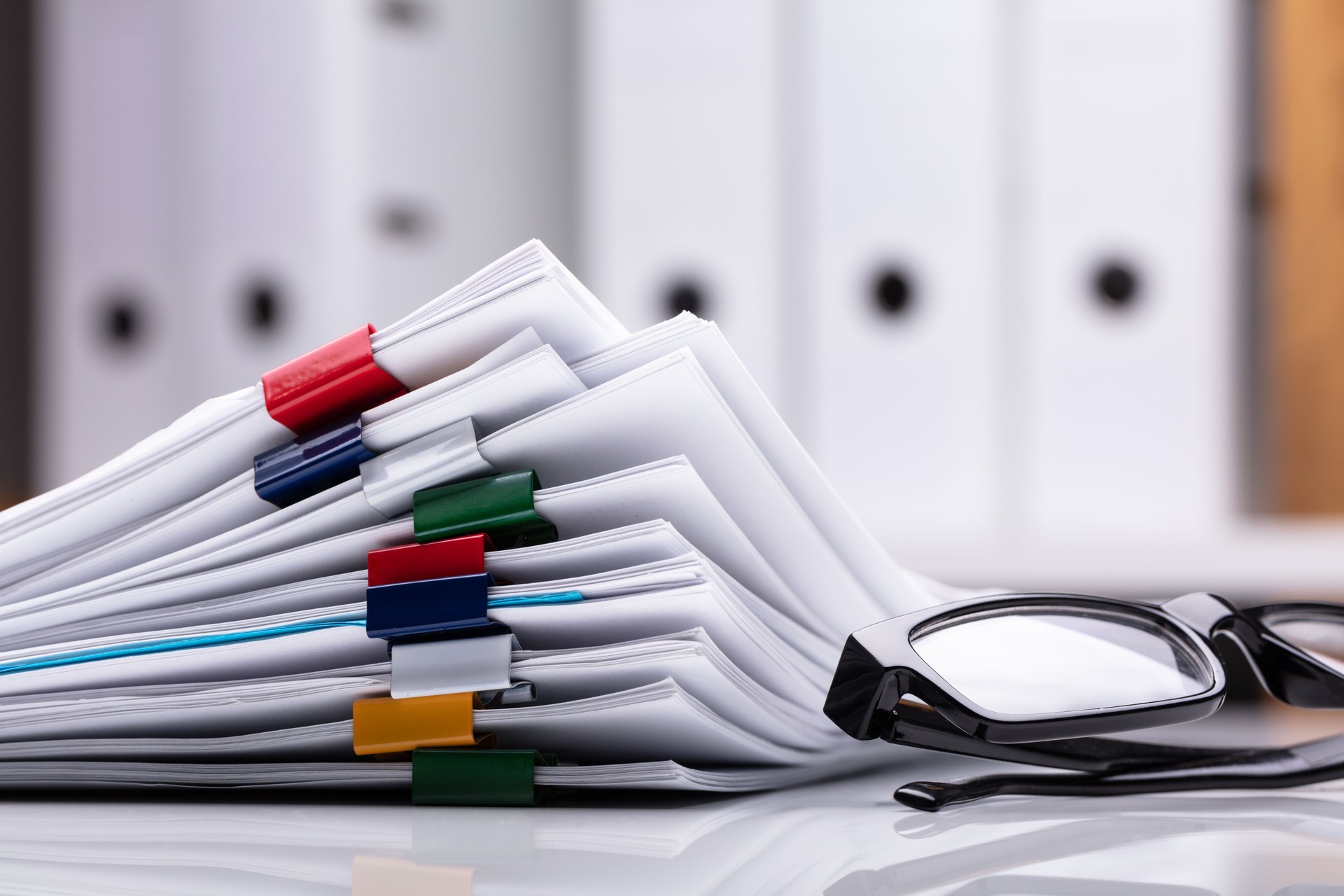 Stacked Documents And Eyeglasses
